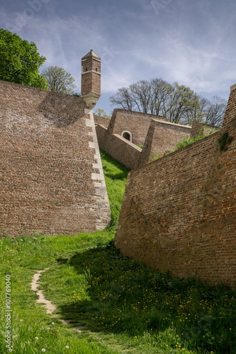 Wachtower and walls of Kalemegdan fortress, Belgrade with track in grass photo