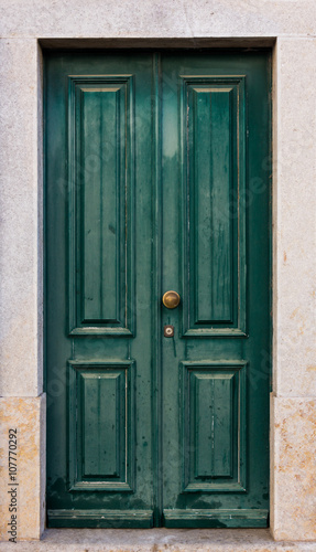 Green door. entrance door in front of residential house.