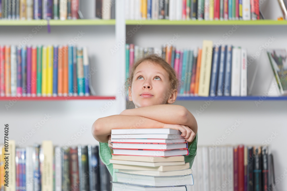 Cute girl reading book in library
Cute girl reading book in library