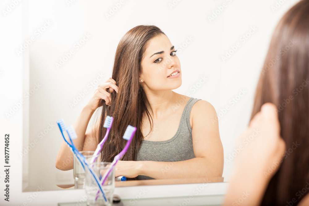 Pretty brunette brushing her hair Pretty brunette brushing her hair