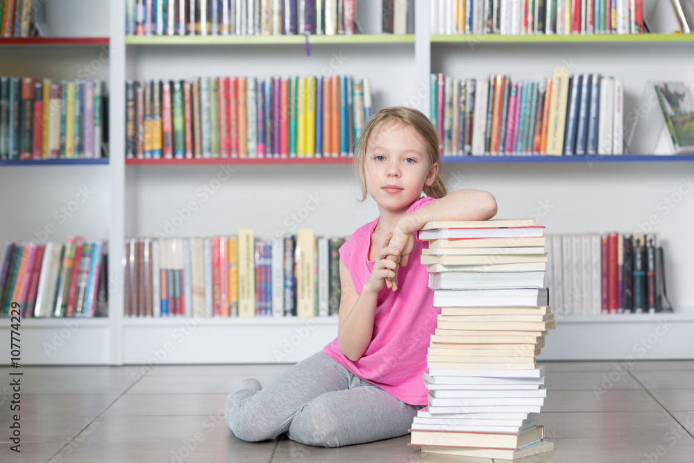 Cute girl reading book in library
Cute girl reading book in library