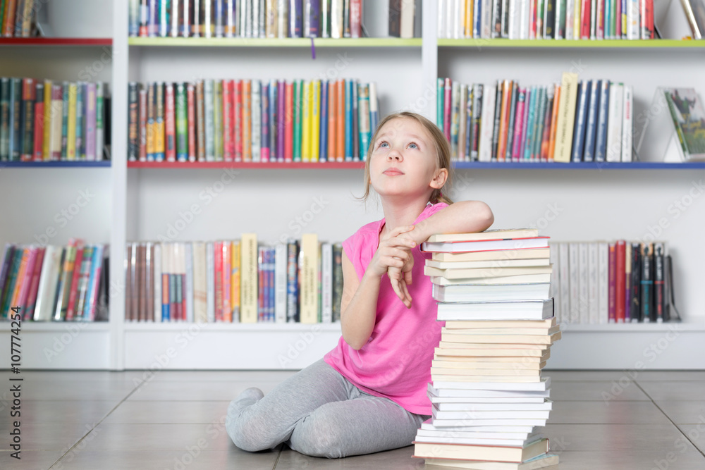 Cute girl reading book in library
Cute girl reading book in library