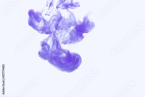 Abstract splash of acrylic paint in water on a white background