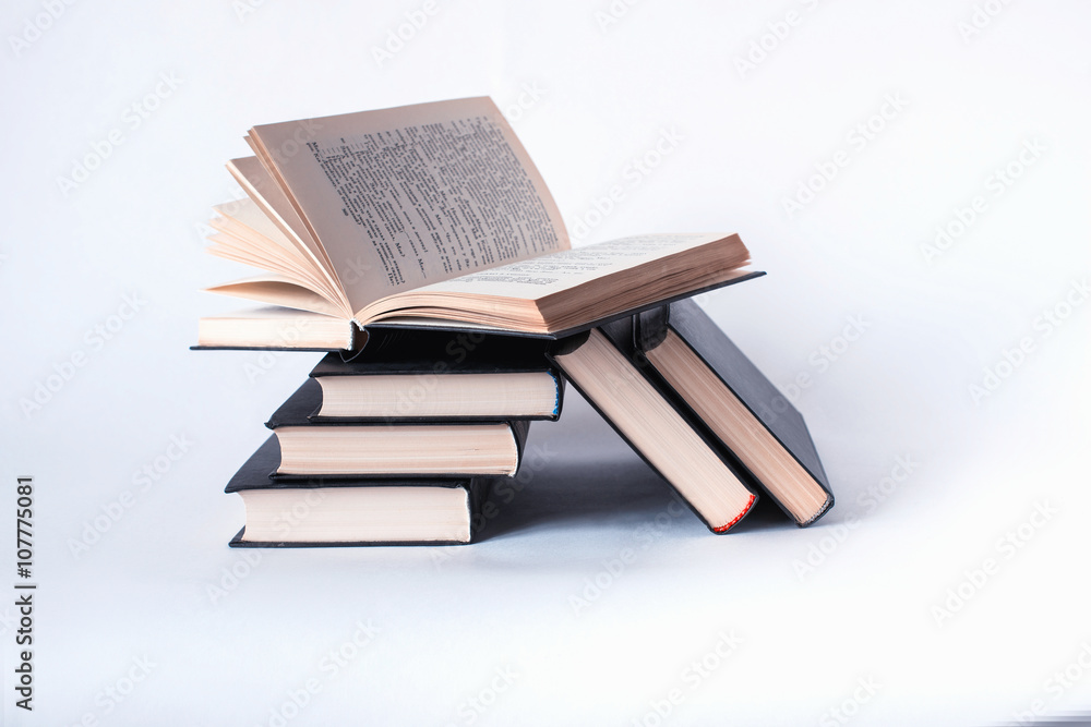Naklejka premium A stack of books lying on a white background, learning, education, study