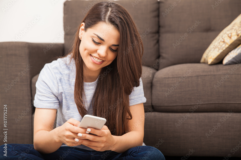Cute woman using a smartphone at home Cute woman using a smartphone at home