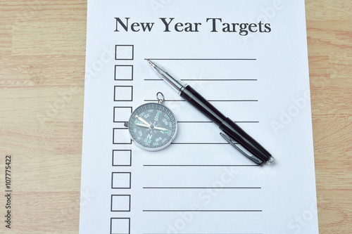 Wallpaper Mural Concept : pen and compass on paper with new year targets word on Torontodigital.ca
