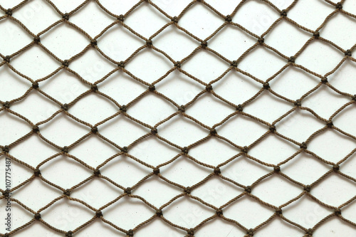 Close up of fish net against white background