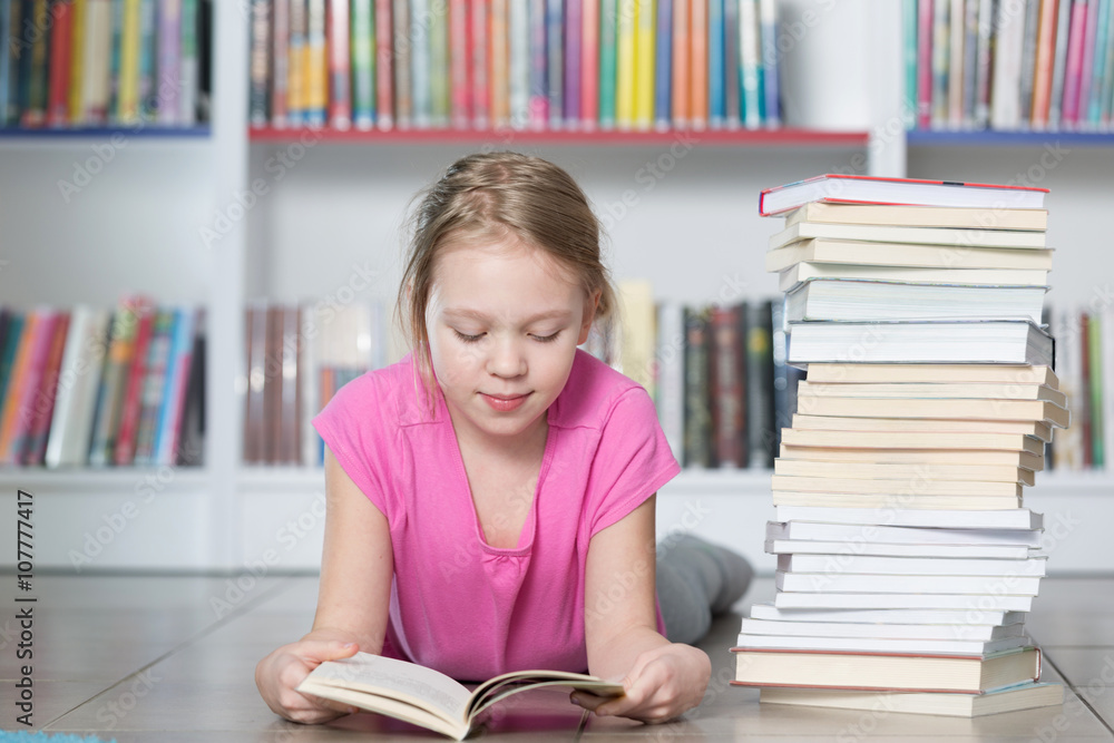 Cute girl reading book in library
Cute girl reading book in library