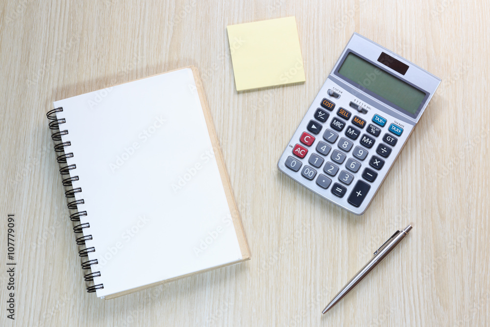 Top view of office desk with notebook, calculator, pen and notebook Top view of office desk with notebook, calculator, pen and notebook