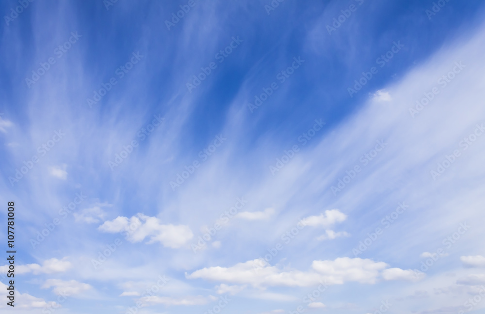 Obraz premium White cirrus clouds and a bright blue sky. Bright, high-contrast picture, nature.