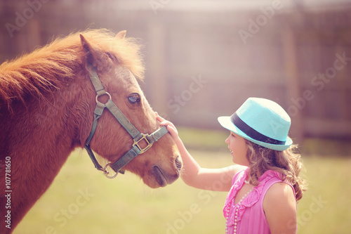 Photo Pony Standing with Little Girl Outside