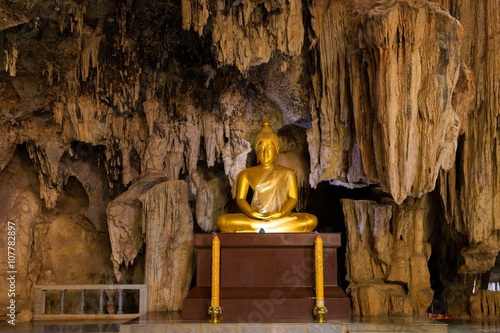 Golden Buddha statue in cave