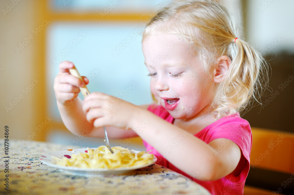 Cute funny little girl eating spaghetti Cute funny little girl eating spaghetti