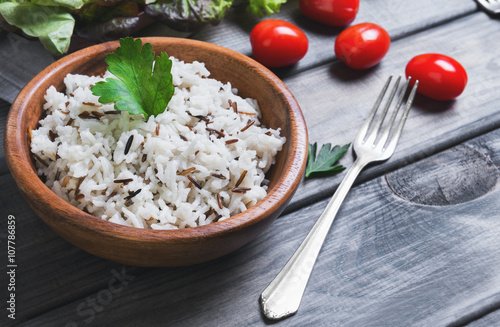 Wooden bowl with cooked white long-grain and wild rice