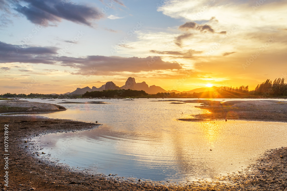 Beautiful sunset landscape with mountain and lake Beautiful sunset landscape with mountain and lake
