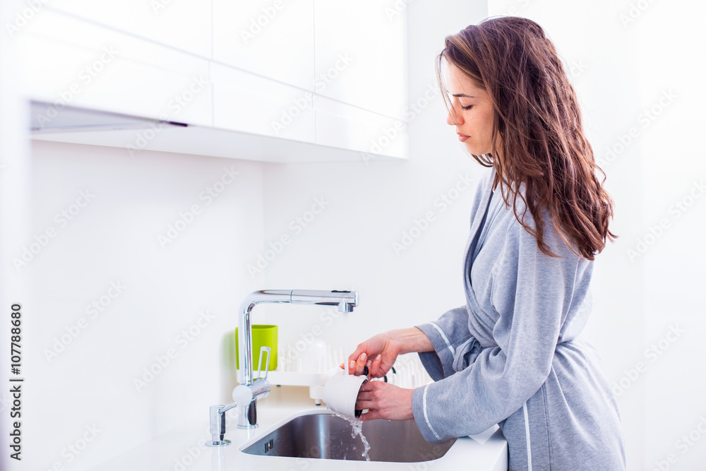 Woman preparing morning coffee in the kitchen Woman preparing morning coffee in the kitchen