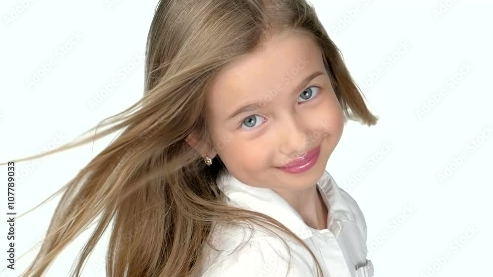Teenage girl blonde smiling and posing on white background,slow motion Teenage girl blonde smiling and posing on white background,slow motion