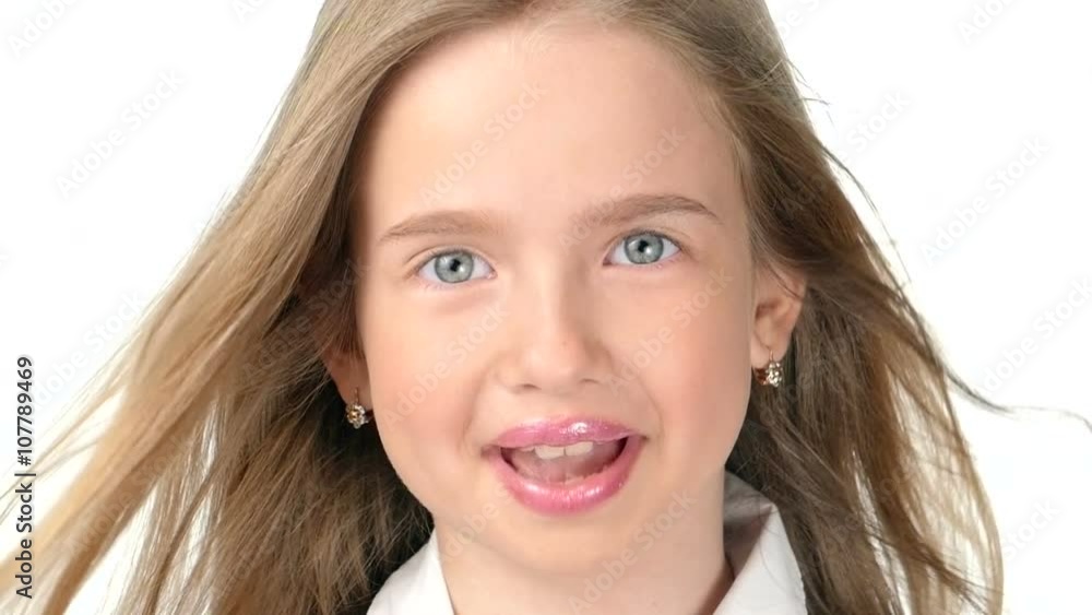 Teenage girl blonde smiling and posing on white background,slow motion Teenage girl blonde smiling and posing on white background,slow motion