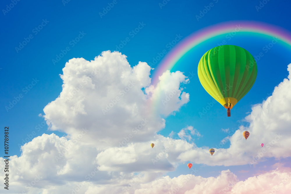 Fototapeta premium colorful hot air balloons and rainbow with cloudy blue sky background