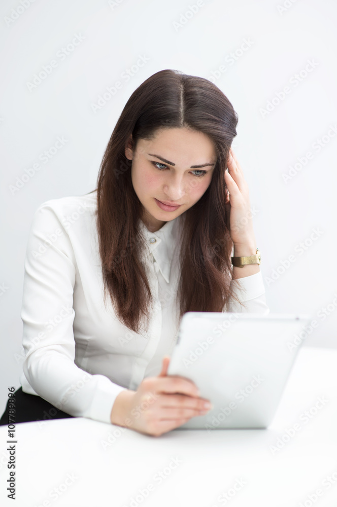 business woman thinking with a tablet in hand business woman thinking with a tablet in hand