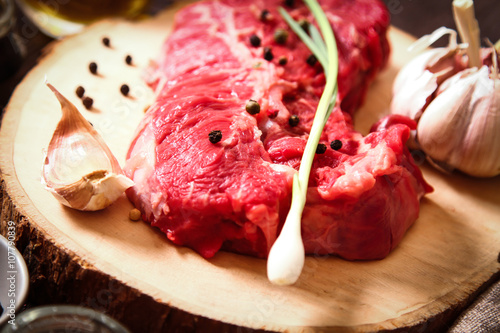 piece of raw meat with herbs and olive oil