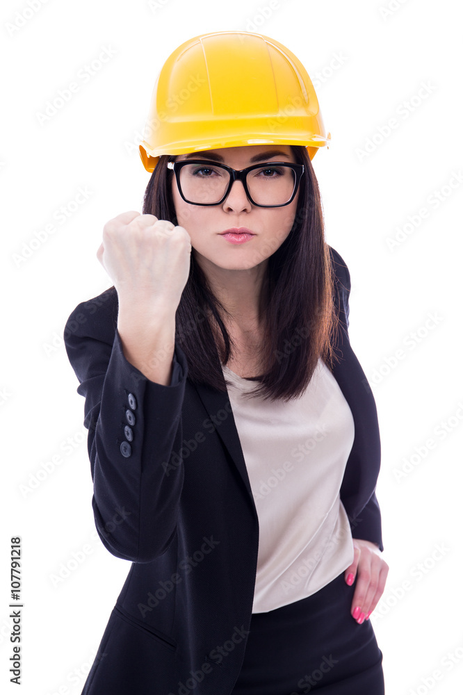 angry business woman architect in yellow helmet showing her fist angry business woman architect in yellow helmet showing her fist