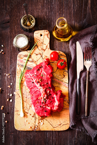 piece of raw meat with herbs and olive oil