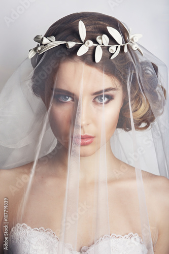 Obraz na płótnie Beautiful bride with fashion wedding hairstyle - on white background