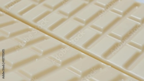 White milk chocolate blocks in a row sweet background slow tilt 4K 2160p 30fps UltraHD video - Junk food background of white chocolate bars tilting 4K 3840X2160 UHD footage 