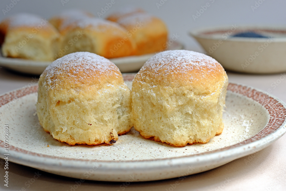 Czech homemade buns with poppy seeds on a plate Czech homemade buns with poppy seeds on a plate