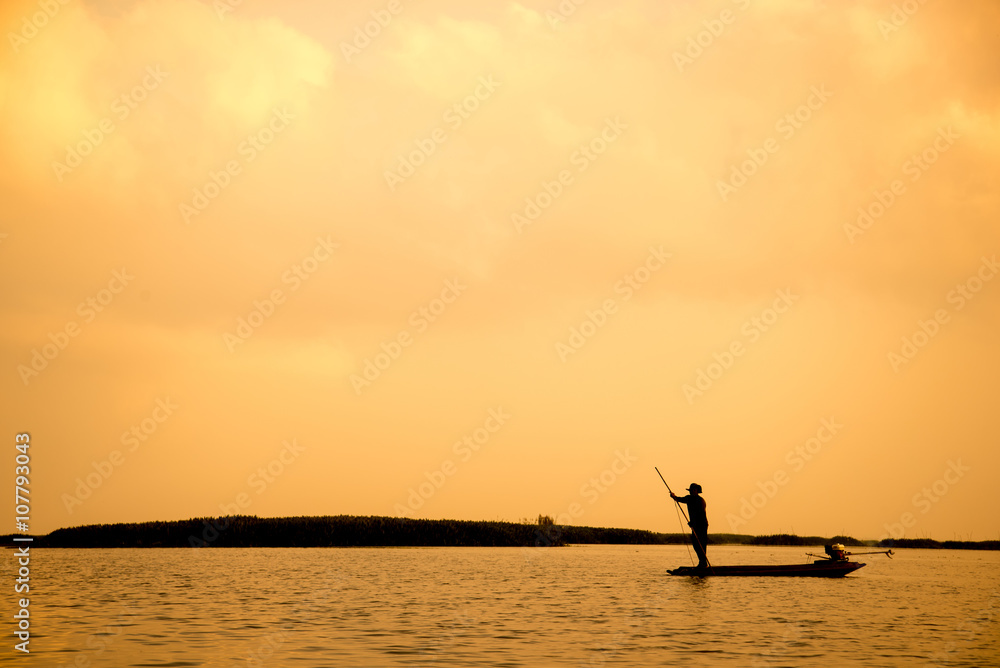 silhouette fisherman is fishing in the lake silhouette fisherman is fishing in the lake