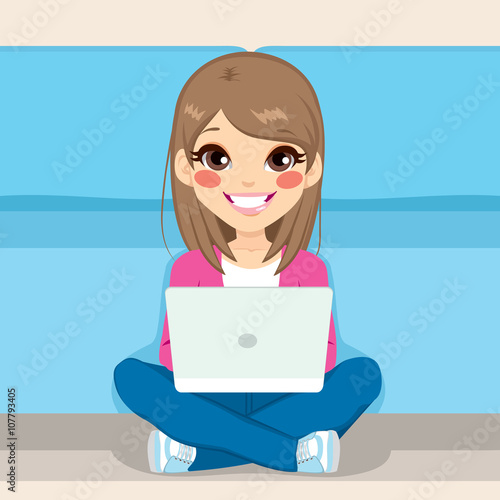Cute teenager girl sitting on the floor with laptop computer in her lap