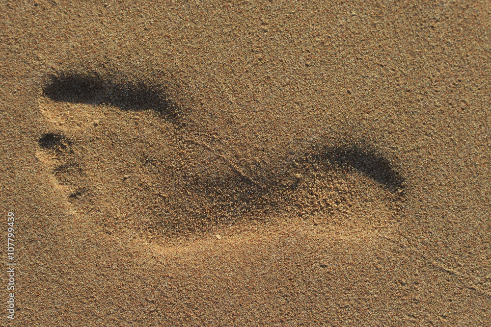 Man's footprint on a sand close-up Man's footprint on a sand close-up