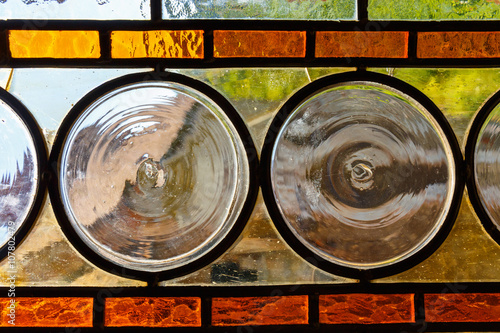 multicolored stained glass window with circural blocks photo