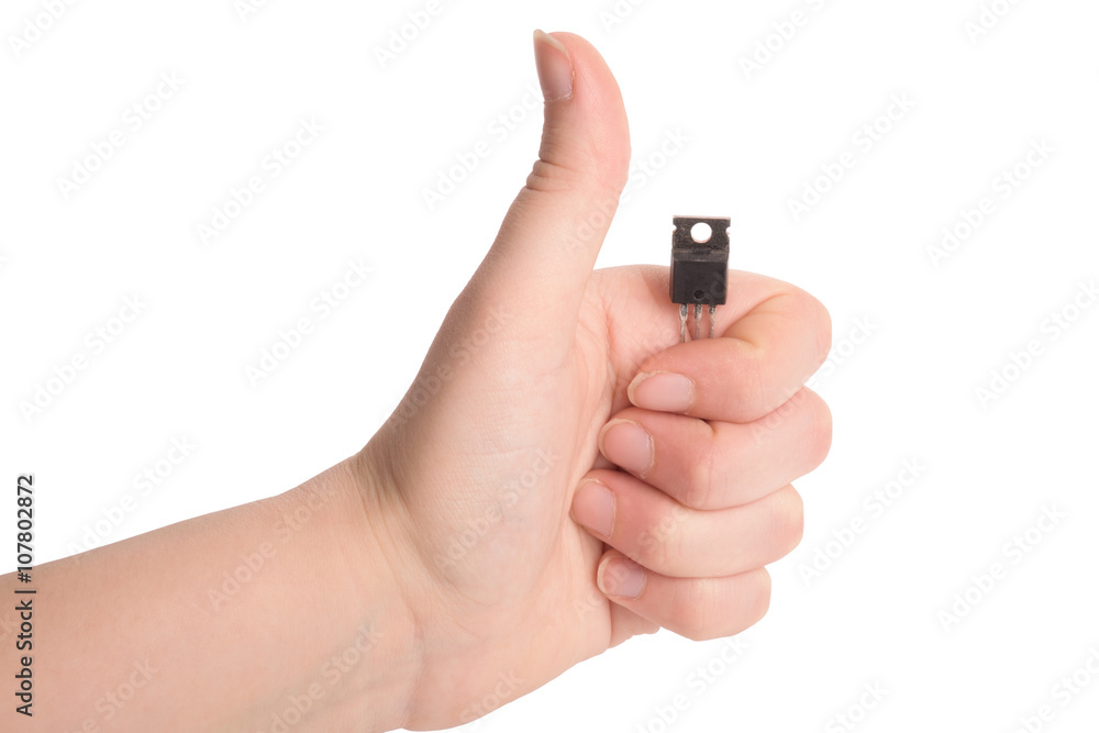Close-up view of young girl hand holding transistor based microchip and gesturing with it, taken on white background. Nanotechnology concept Close-up view of young girl hand holding transistor based microchip and gesturing with it, taken on white background. Nanotechnology concept