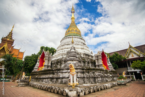 A golden buddha statue and a white pagoda