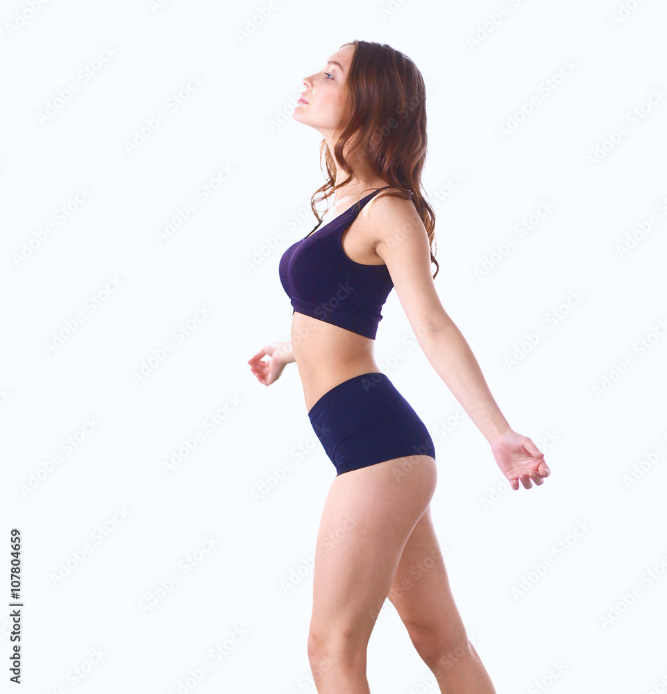 Young fitness girl standing on green grass Young fitness girl standing on green grass