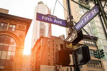 Street sign of Fifth Ave and West 33rd St at sunset in New York City - Manhattan district urban area