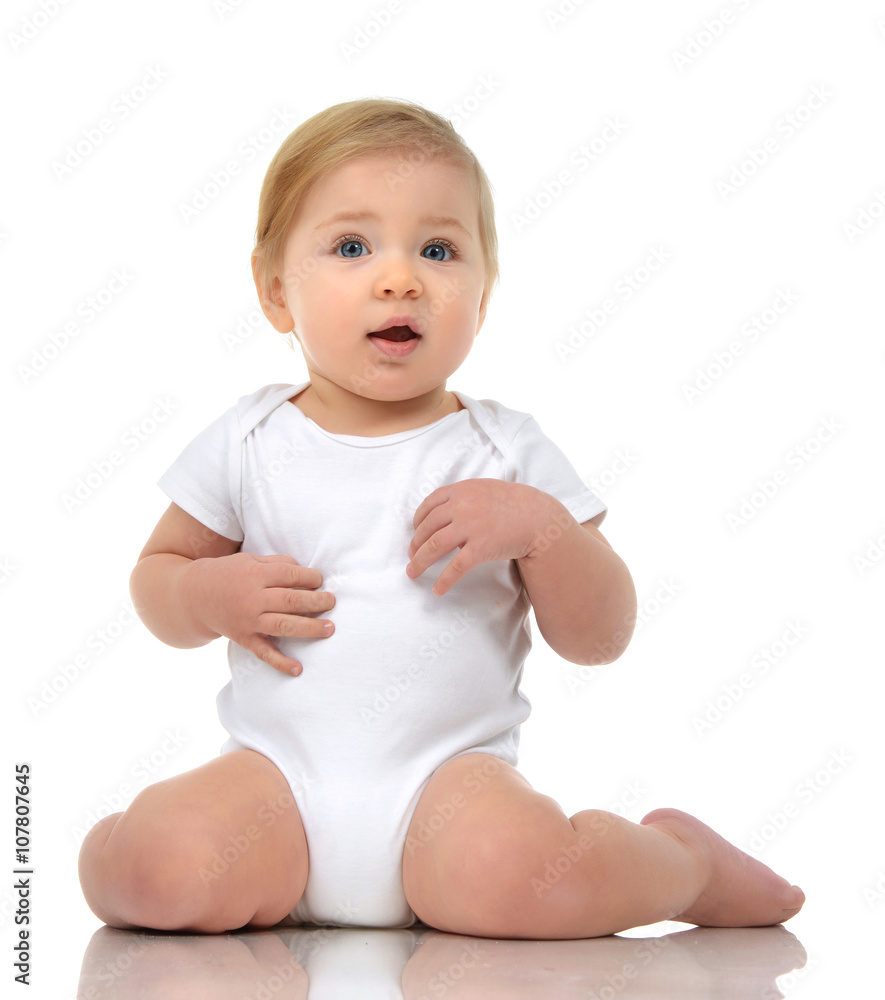 Infant child baby girl toddler sitting of floor happy looking st Infant child baby girl toddler sitting of floor happy looking st