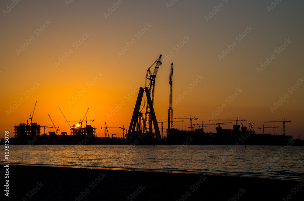 oil tower in sunset silhouettes orange sky