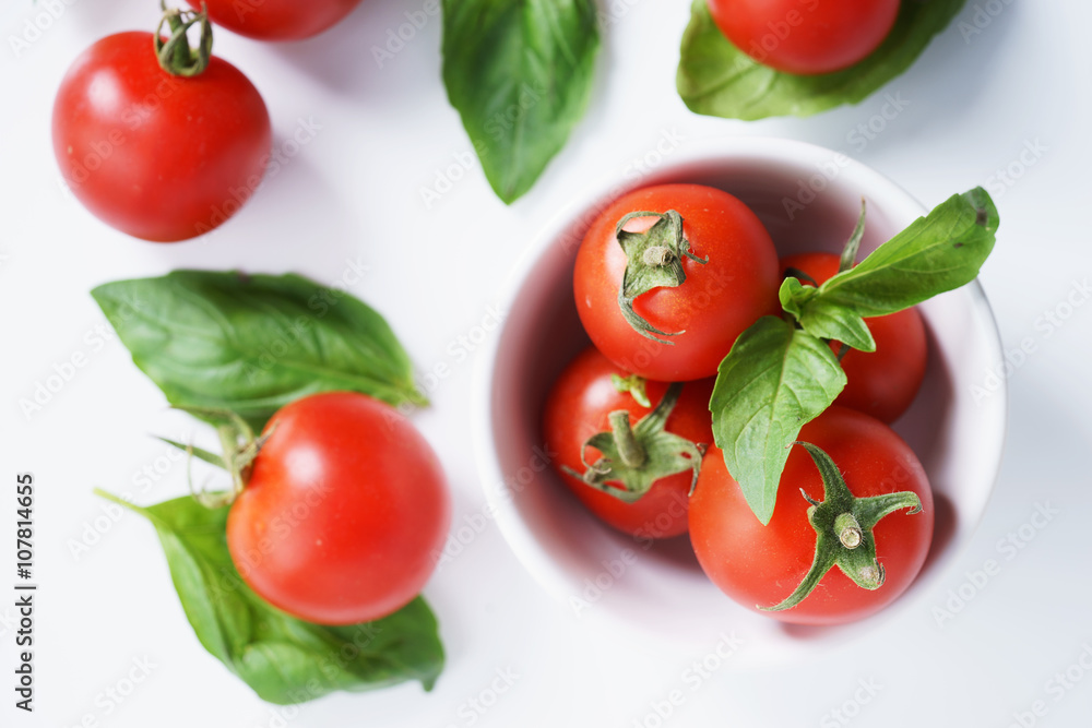 Fototapeta premium red ripe tomatoes and basil leaves