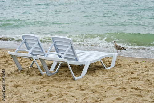 chaise longue on a beach on a background of sea