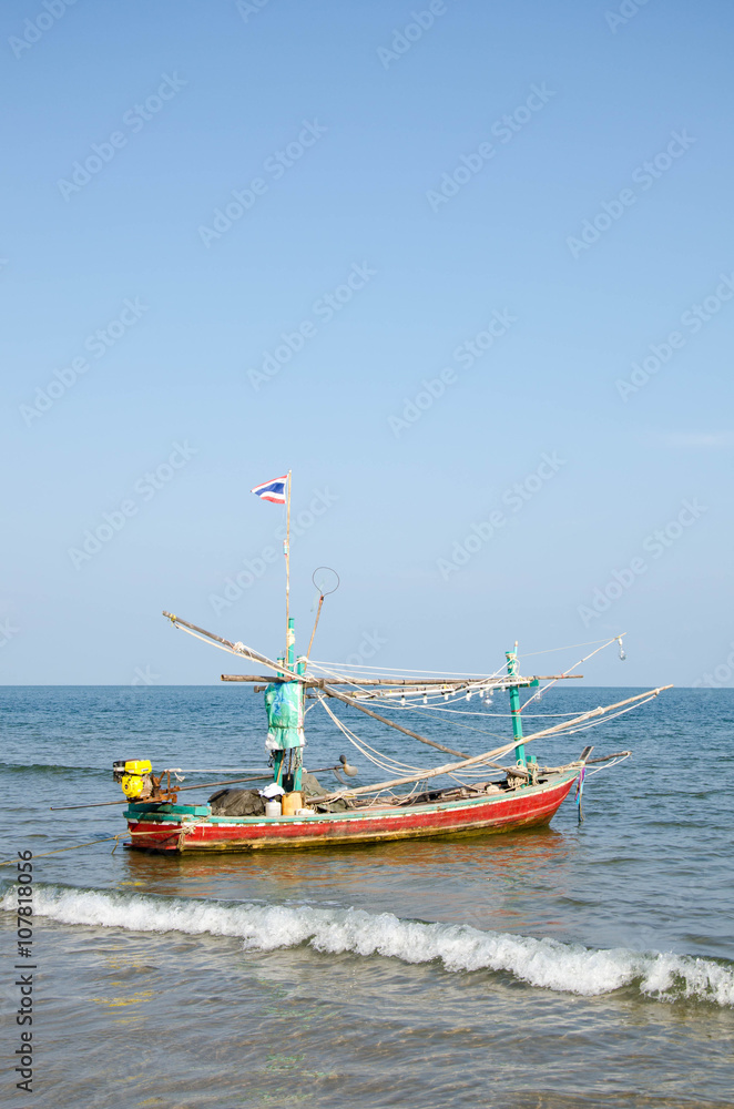 old wooden local fishing boat on on sea coast and beach with sum