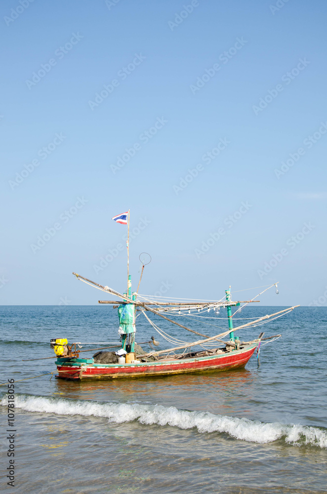 old wooden local fishing boat on on sea coast and beach with sum old wooden local fishing boat on on sea coast and beach with sum