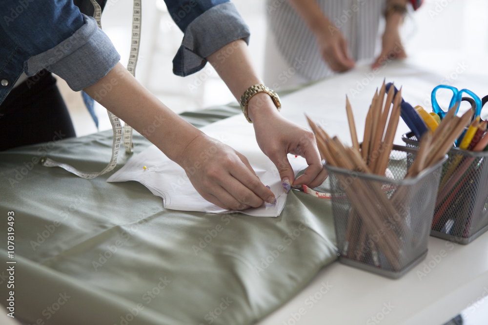 Two women are making the clothes in the studio