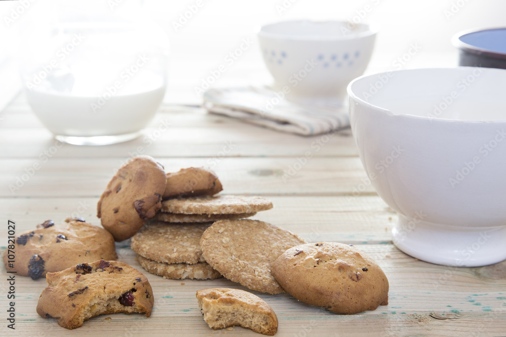 Cookies to breakfast. Good morning with biscuits and milk on a wooden table Cookies to breakfast. Good morning with biscuits and milk on a wooden table