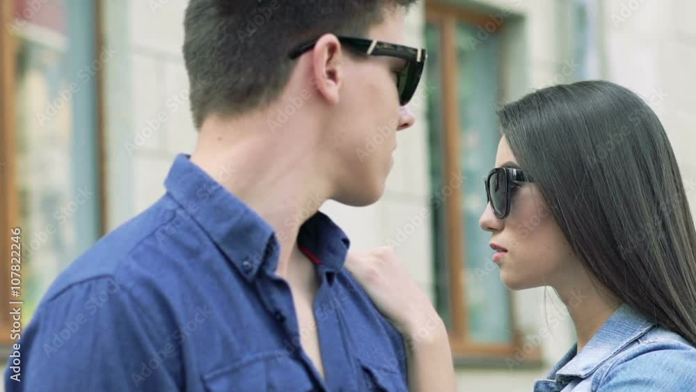 Close up of couple, girl undress sunglasses and looking on boy. Slowly Close up of couple, girl undress sunglasses and looking on boy. Slowly