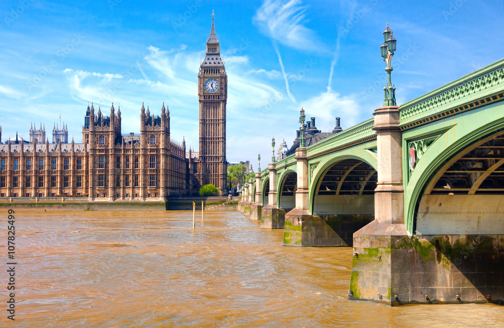 London westminster houses of parliament and bridge on river thames in a sunny day