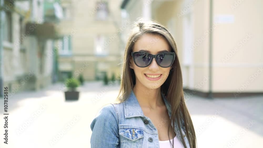 Girl walking on the street, camera behind her, she turned to it and smiling. 4k Girl walking on the street, camera behind her, she turned to it and smiling. 4k