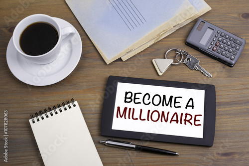 Become a Millionaire. Text on tablet device on a wooden table